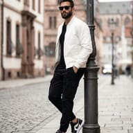 Gemini AI Generated Photo of a Stylish bearded man in a white jacket and sunglasses leaning against a lamppost.