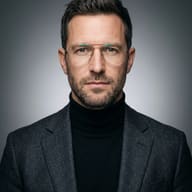 AI generated studio portrait of a corporate man wearing wire-frame glasses, a black turtleneck, and a textured grey blazer against a neutral gradient background.