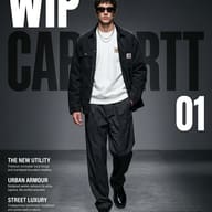 Modern Male Workwear Magazine Cover AI Photo Editing Prompt. AI generated digital fashion magazine cover featuring a man in a black chore jacket and white t-shirt walking on a studio runway.