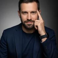 Male Professional in Blue Blazer AI Photo Editing Prompt. AI generated studio portrait of a bearded man in a navy blue blazer wearing a smartwatch and posing thoughtfully with a finger to his temple.
