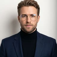 Professional Man in Navy Blazer AI Photo Editing Prompt. AI generated studio portrait of a bearded man with glasses wearing a black turtleneck and a tailored navy blue blazer.